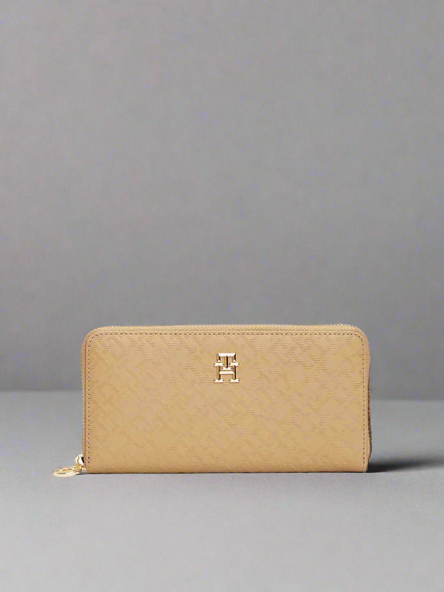 Beige wallet with a gold zipper and logo on a white background