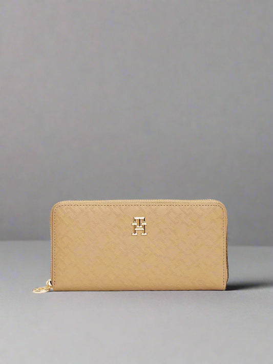 Beige wallet with a gold zipper and logo on a white background